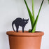 Black cat plant stake in clay pot.
