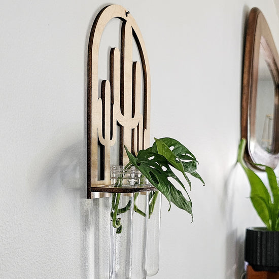 Wall mounted hanging propagation station for growing plant cuttings in water. Wood cut cactus design.