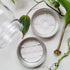 Two clear acrylic mason jar lid inserts in both designs available on the site.