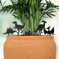 Black dinosaur indoor plant accessories in a terracotta pot with green plants.