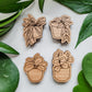 Four handcrafted magnets featuring different hoya plant designs engraved in cherry wood.