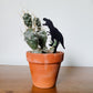 Mini T-Rex plant stake made from black acrylic displayed in 3 inch pot with a houseplant.