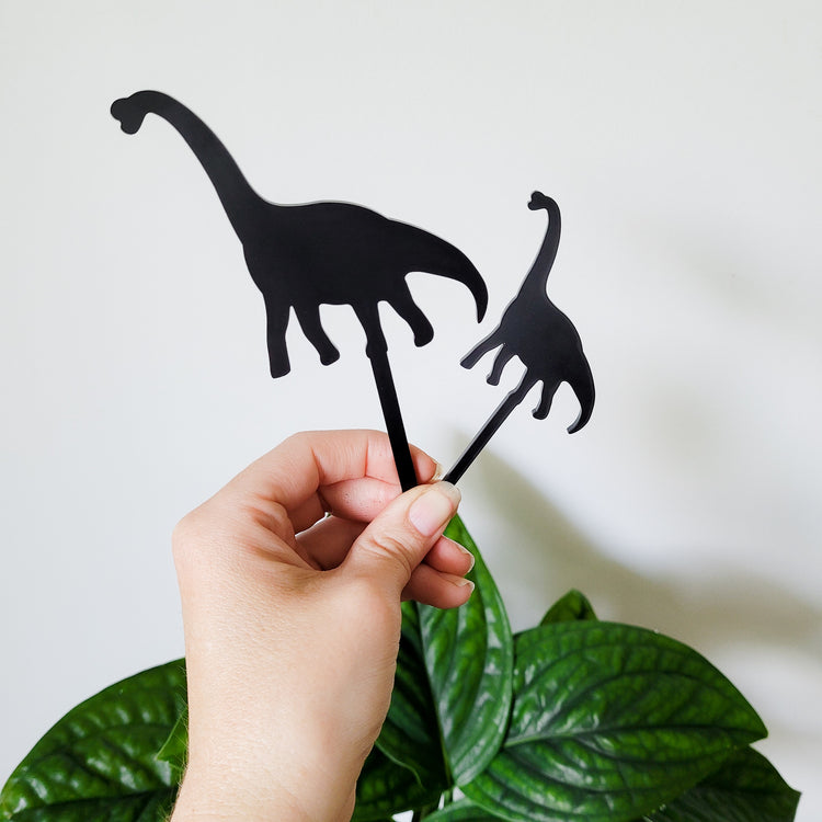 Standard and Mini Brachiosaurus plant stakes held in hand for size perspective.